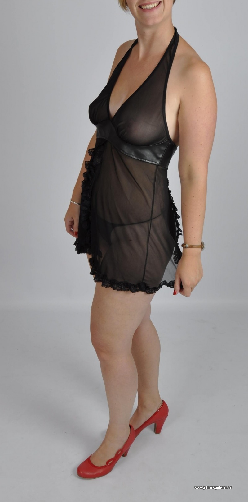 stripping out of a black see thru dress