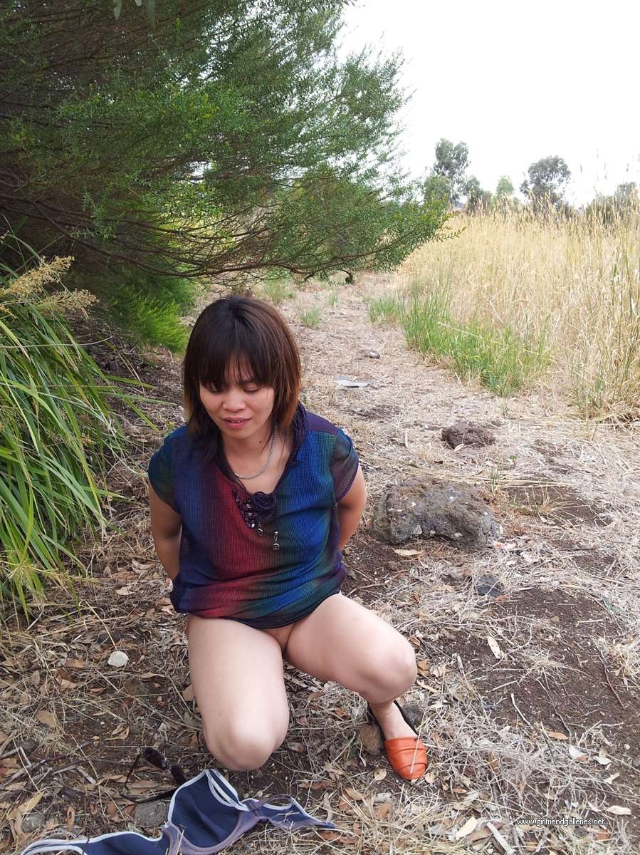 Chinese wife striping in the park
