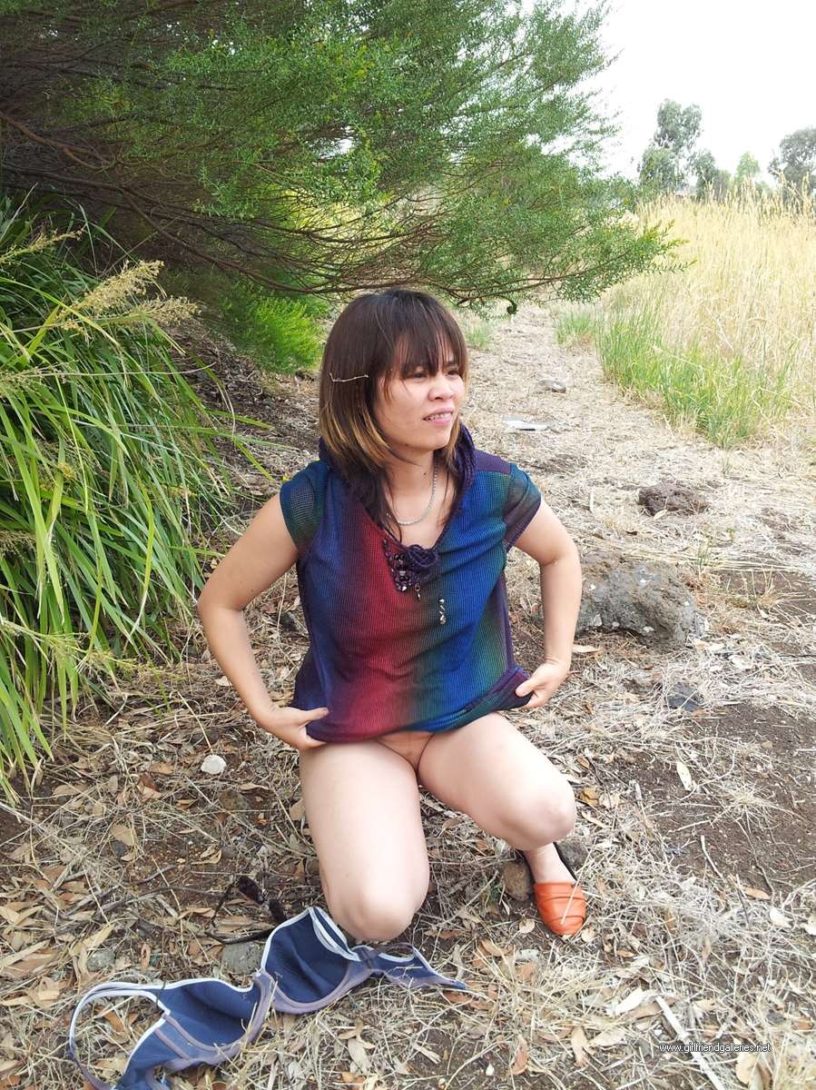 Chinese wife striping in the park